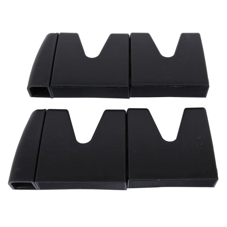 Black plastic modular vehicle organizer pieces with curved slots and textured grip