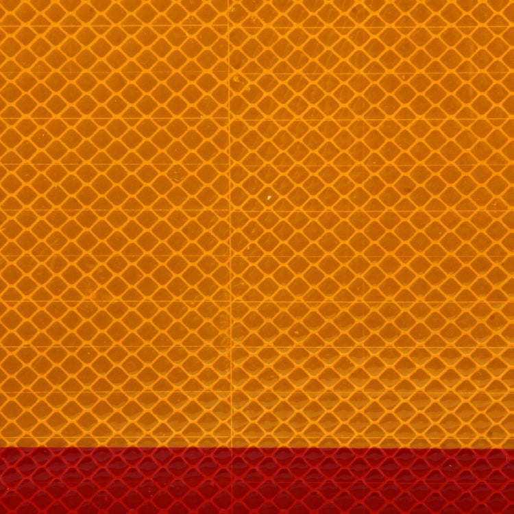 Reflective warning sign sticker close-up, orange pattern with dark red strip