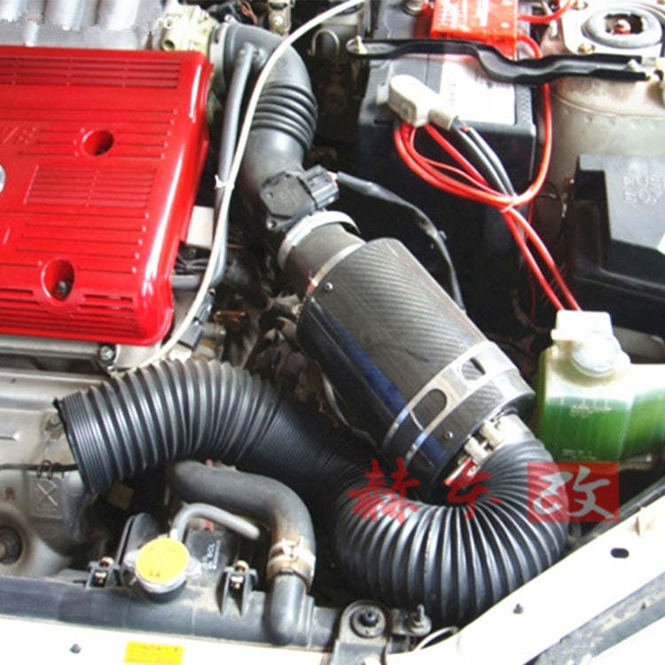 Installed universal air intake hose: black ribbed tube with metal clamps and coupler
