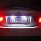 LED license plate lights glowing white under clear lens, two-unit set
