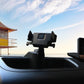 Black car GPS bracket mounted on dashboard with phone holder on top