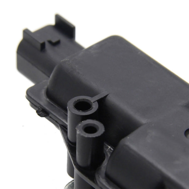 Car tailgate lock actuator motor close-up of black connector and mounting tabs