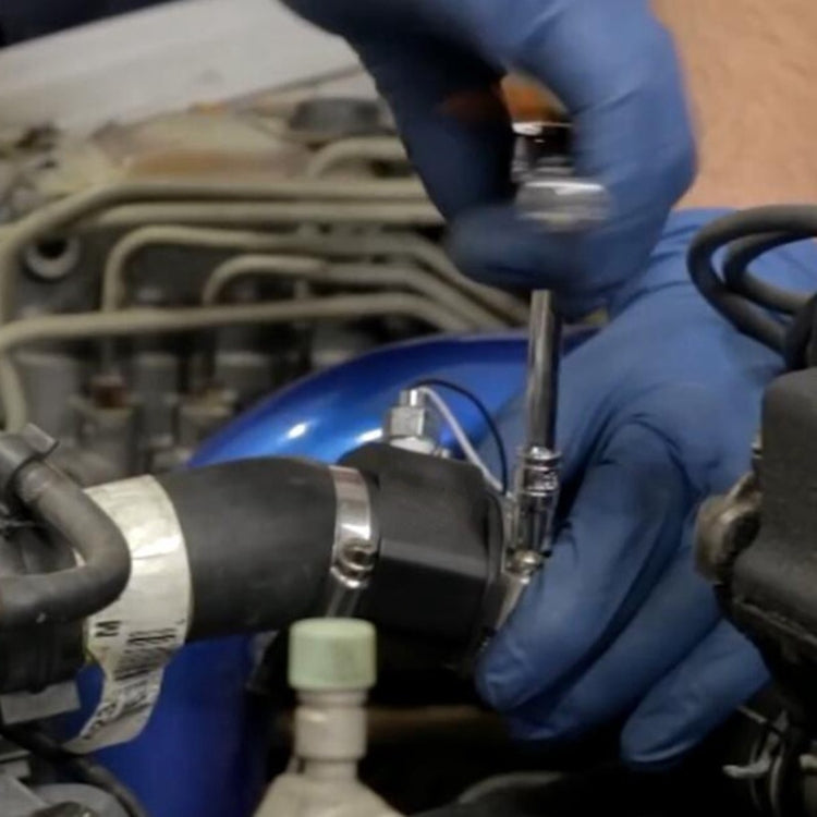 Black radiator temperature sensor adaptor installed on engine hose