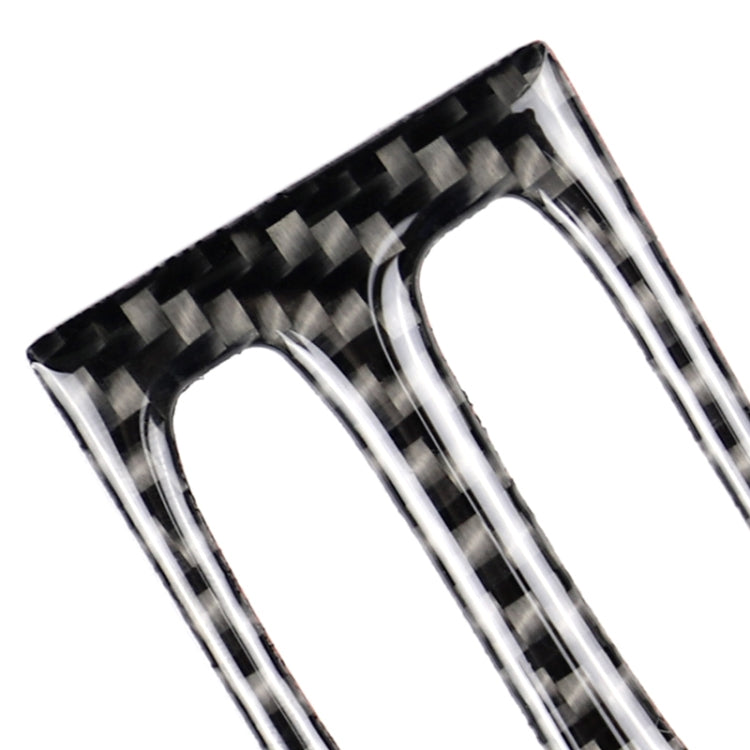 Close-up carbon fiber air outlet trim insert with two vertical openings and silver border details.