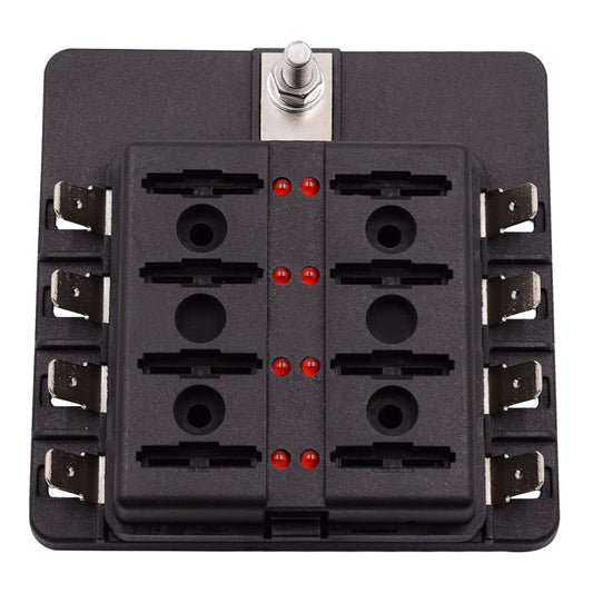 Car fuse box terminal block, open front with eight fuse holders and central red indicator dots