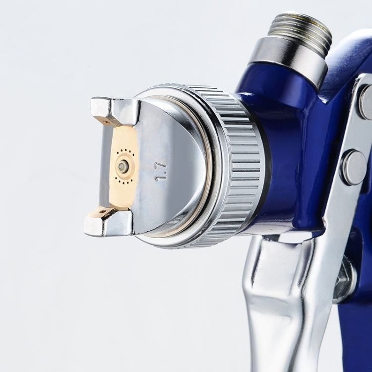 Close-up of blue spray gun body with metal nozzle and adjustment ring