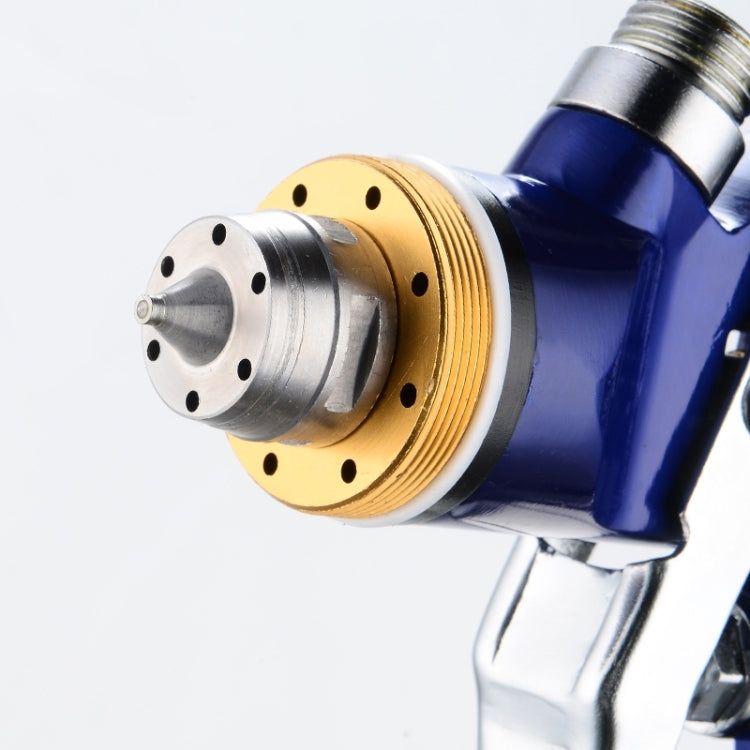 Macro view of blue spray gun with circular nozzle head and gold ring seal
