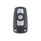 Black key fob remote with lock text and circular control button on silver insert