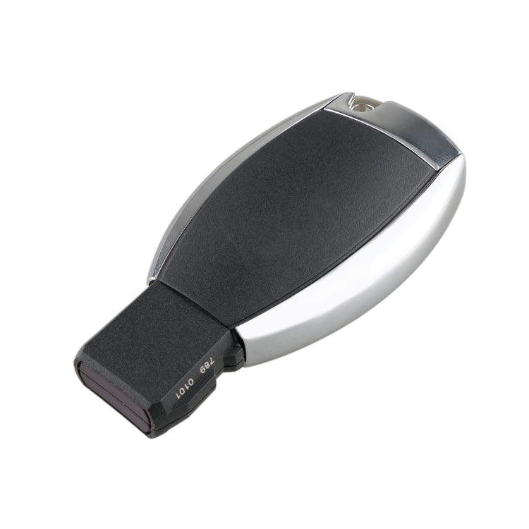 Black remote key fob with silver sides and angled flip blade, compact design
