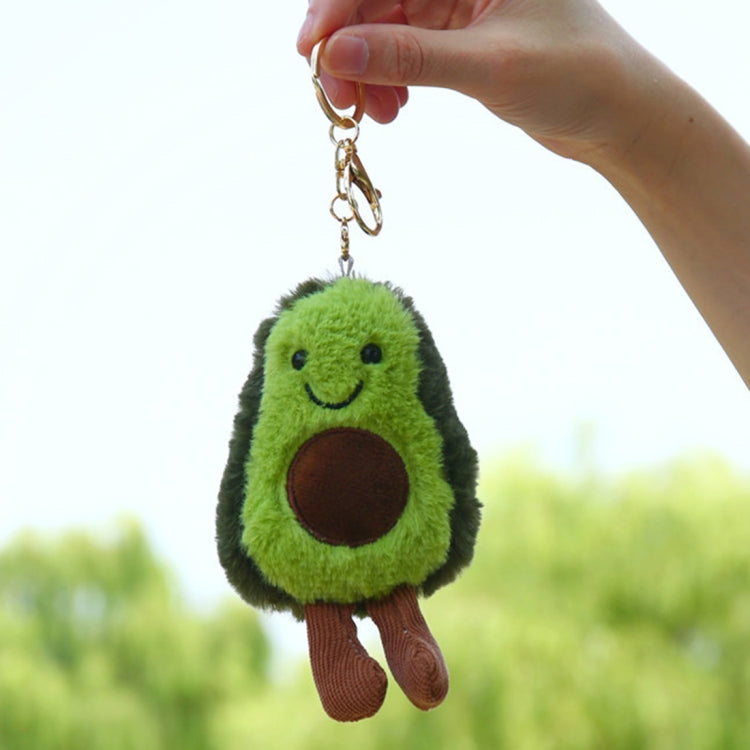 Green plush avocado key ring with smiling face, brown patch, and dangling chain