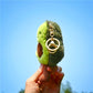 Green plush avocado key ring with metal key loop and chain, side close-up
