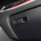 Carbon fiber-pattern switch bezel on car armrest panel with oval frame and circular cutout