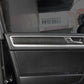Black carbon fiber door panel trim sticker installed along inner door handle bezel