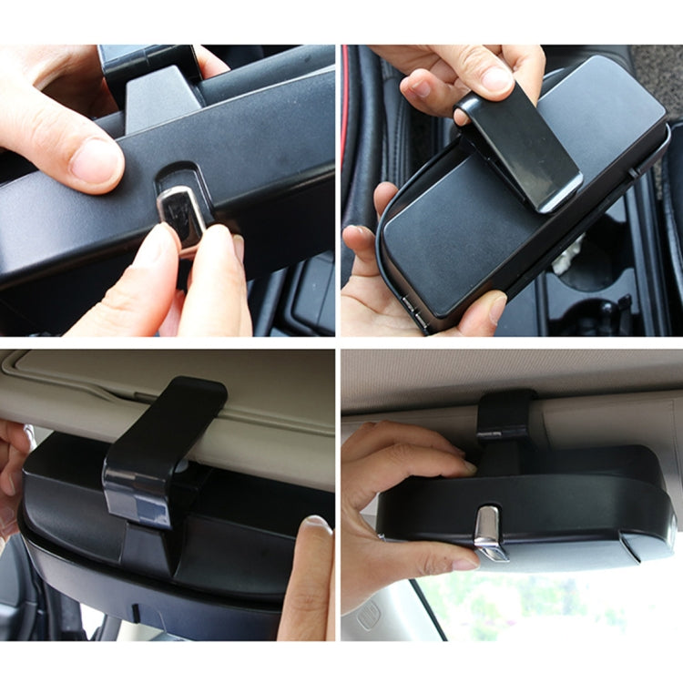 Black car sunglasses case clipped to dashboard, hands adjusting the lid