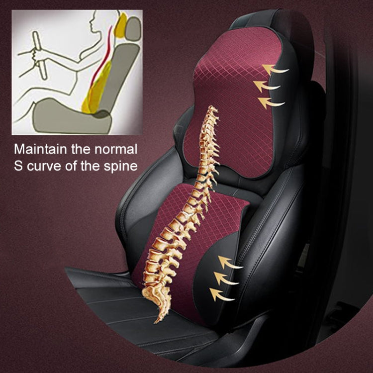 Red lumbar support pillow with black side panels placed on a car seat