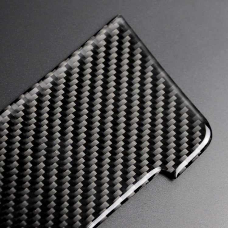 Carbon fiber-look panel sticker close-up, glossy black weave with silver edge