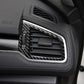 Installed carbon fiber air vent trim surround with inner slats, textured black weave