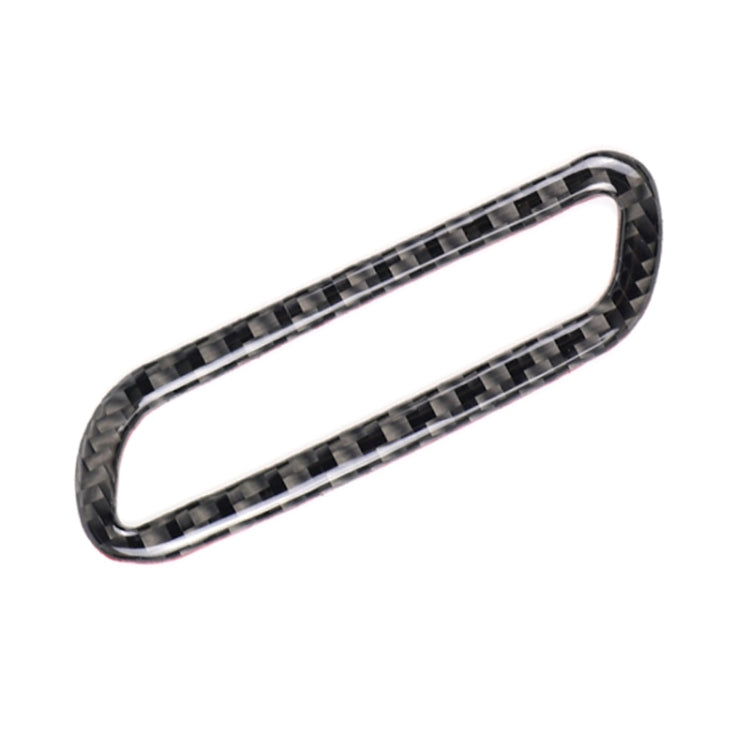 Carbon fiber-look oval trim piece with glossy black and silver crosshatch pattern