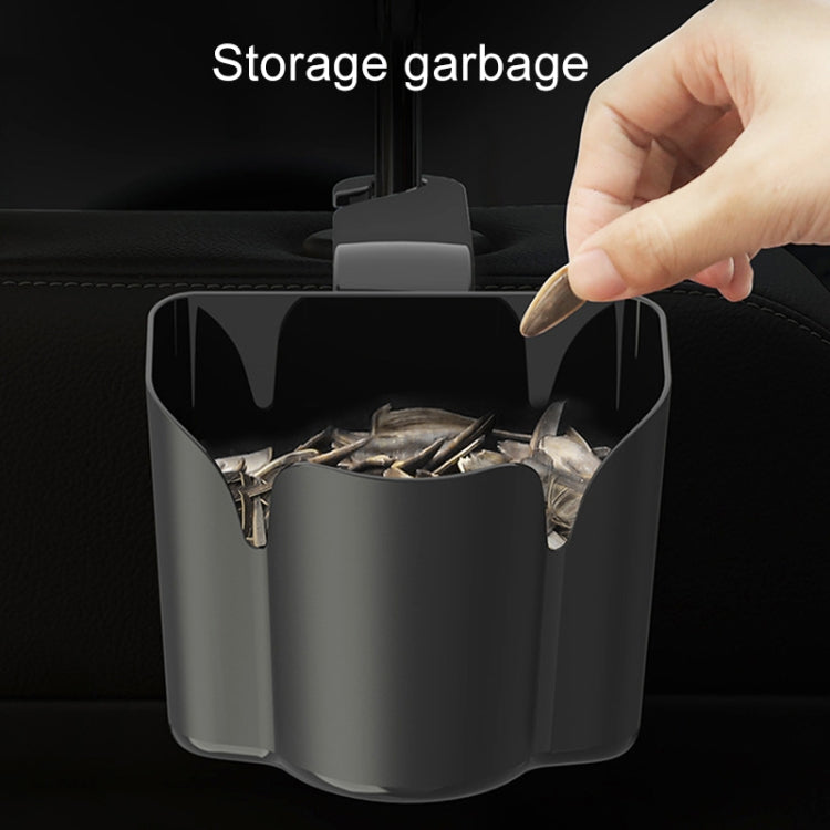 Car back seat storage trash bin on seat, filled with small paper scraps