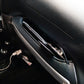 Mounted black car door handle storage tray with glossy trim inside