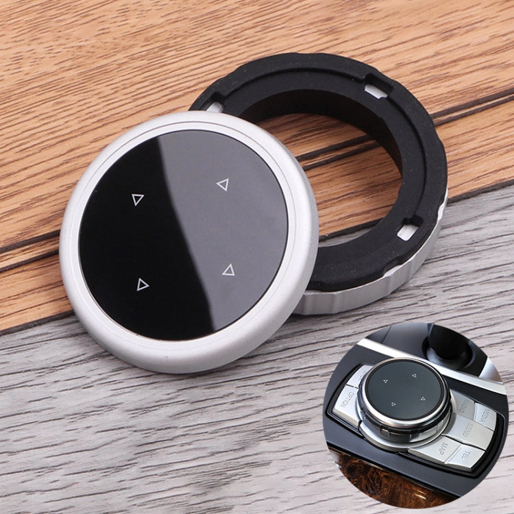 Round IDRIVE knob cover with split black/gray face, silver rim, and arrow icons