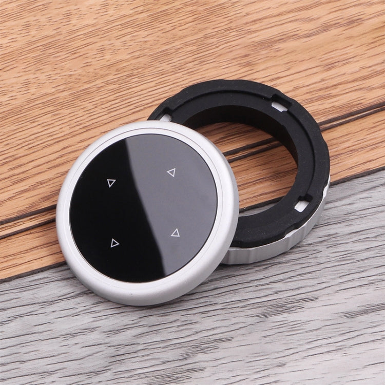 Round IDRIVE knob cover with silver rim, split black/gray face, and black mounting ring