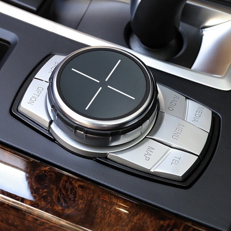 IDRIVE knob cover on dashboard, round black/gray cross dial with silver ring and buttons
