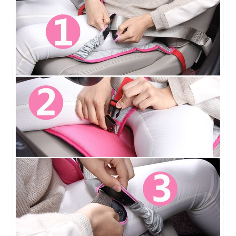 Hands fastening the clip and buckle straps on a pink car safety seat protective pad