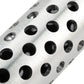 Close-up of perforated metal mesh on a silver shift knob with black openings