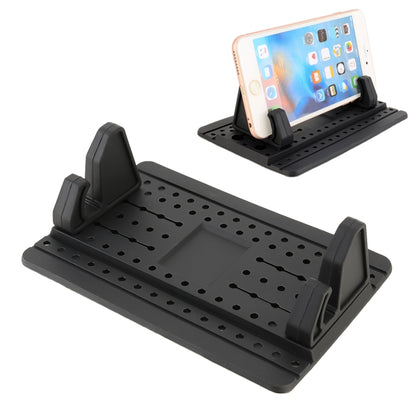 Car dashboard phone holder with black silicone base and adjustable side grips