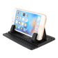 Black silicone car phone holder with perforated tray and side grips holding a phone