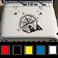 Black compass rose and mountain PVC sticker on a car hood, with color swatches