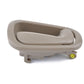 Beige inner door handle with mounting tabs and yellow connector detail