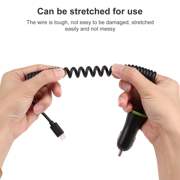 Spring cable car charger shown stretched between hands, black with green accent ring