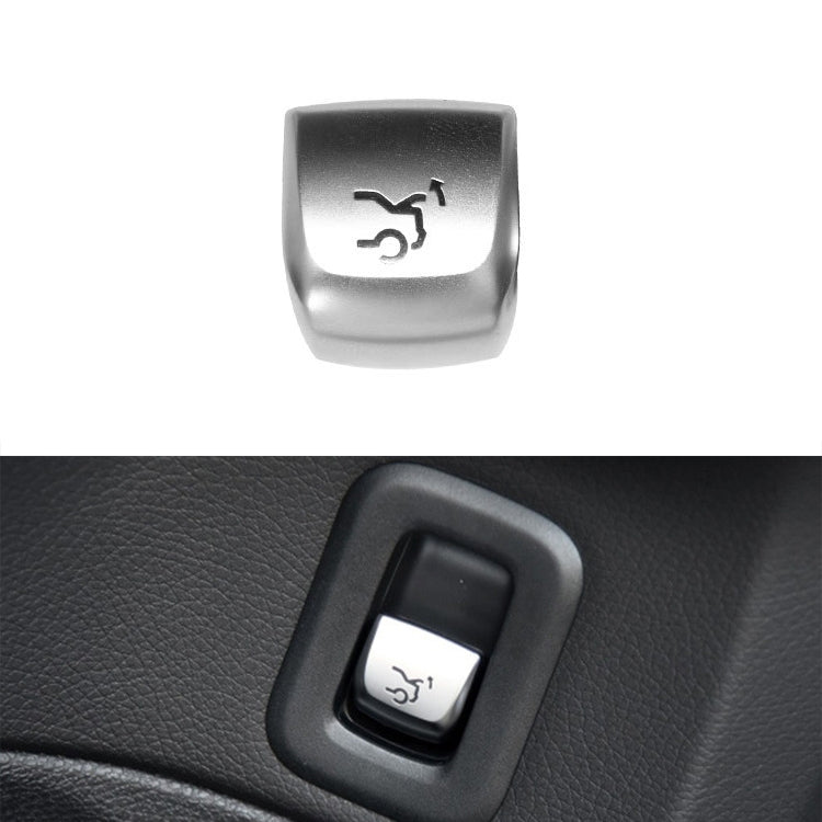 Car trunk switch button with silver cap and black bezel, trunk icon on the front