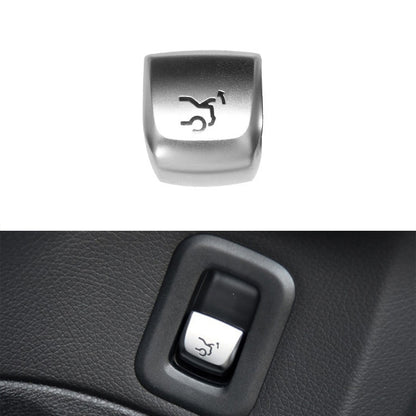 Car trunk switch button with silver cap and black bezel, trunk icon on the front