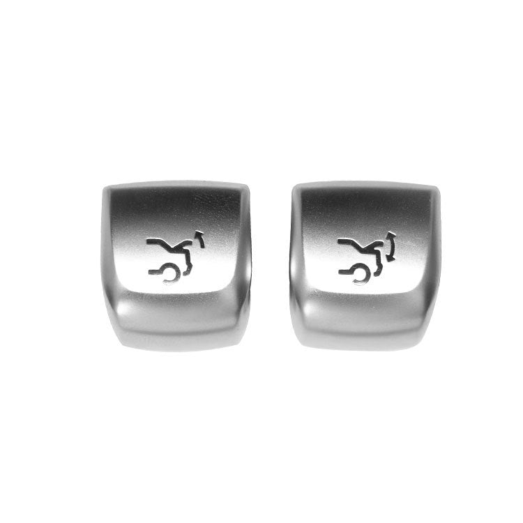 Car trunk switch button pair, silver caps with trunk icon on front faces