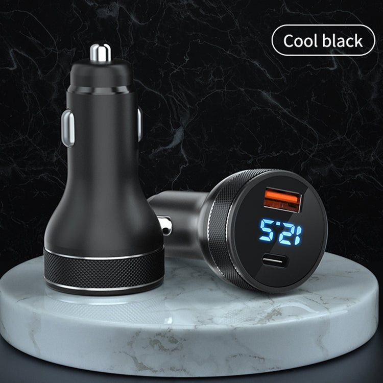 Black dual-port car charger with blue digital power display and textured grip