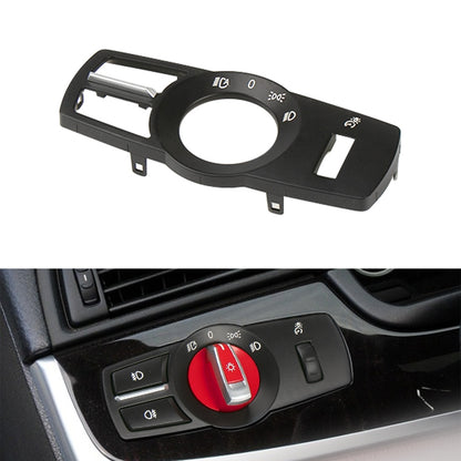 Black headlight switch panel with circular dial, indicator icons, and light switch buttons
