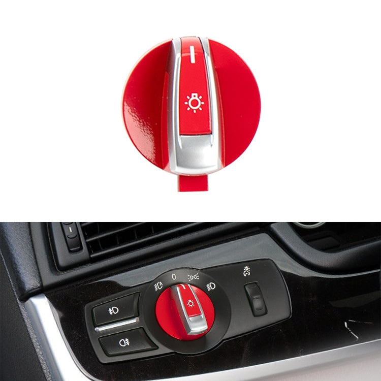 Red headlight switch knob on car dash, with silver light icon dial