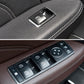 Window switch with multiple buttons and arrow control, close-up on car door armrest