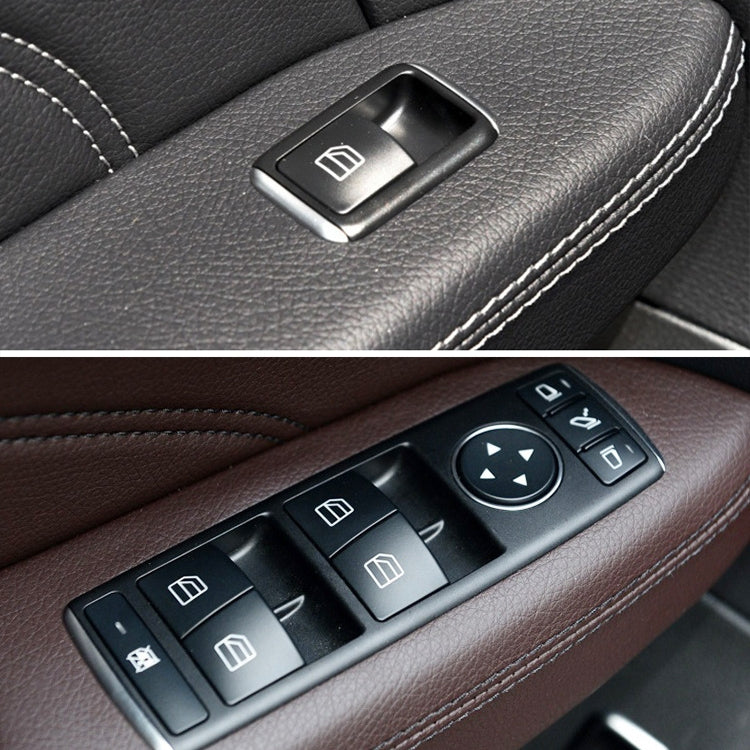 Window switch with multiple buttons and arrow control, close-up on car door armrest