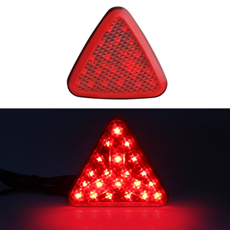 Triangle LED bike tail light with red lens, glowing red