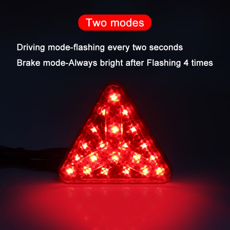 Triangle LED bike tail light glowing red, showing two operating modes