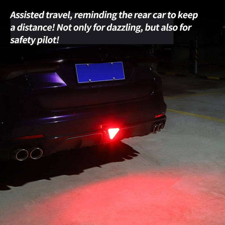 Triangle LED bike tail light glowing red on the rear, bright warning light