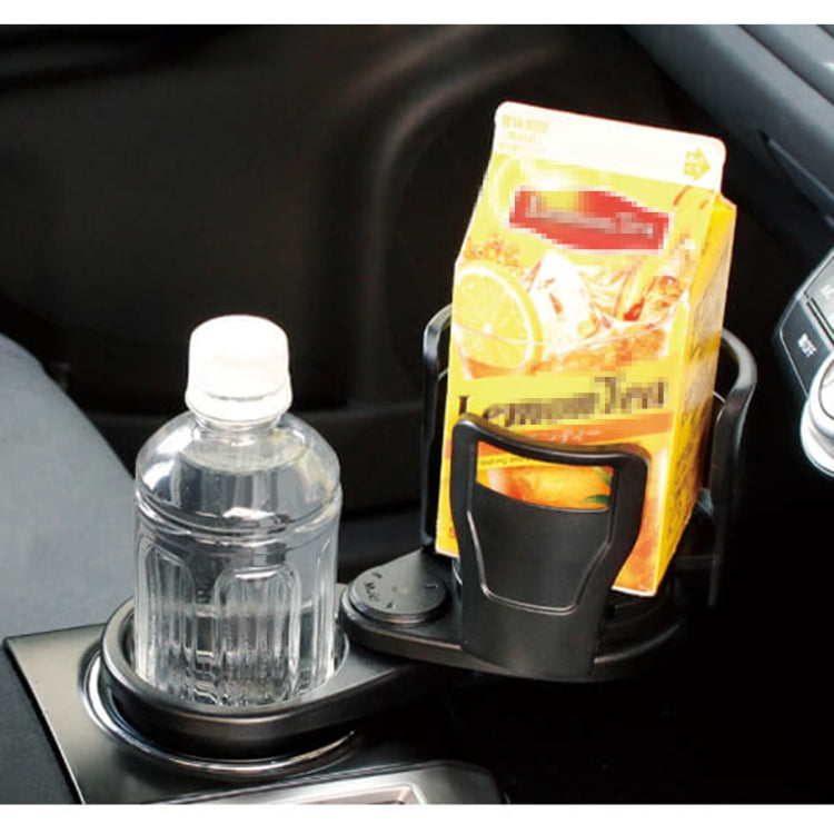 Black universal car cup holder with adjustable grip ring, holding a plastic bottle