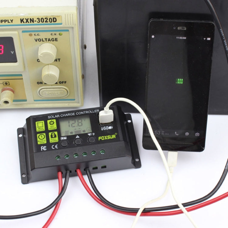 FOXSUR 10A solar charge controller connected to a phone and panel, compact unit