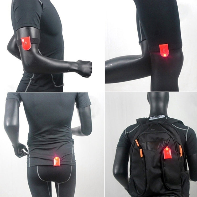 Red LED magnet clip safety light attached to black running sleeve