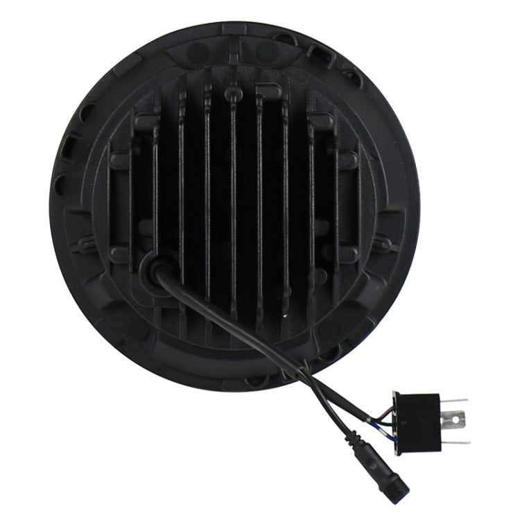 Single 7-inch round LED headlight rear with black heat-sink fins and wiring