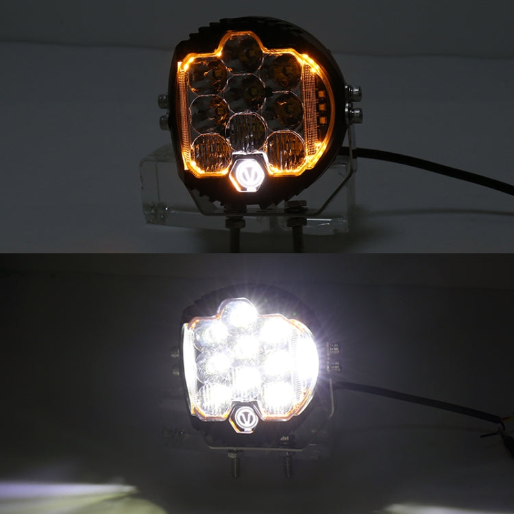 LED headlight showing amber ring and bright white beam in dark conditions